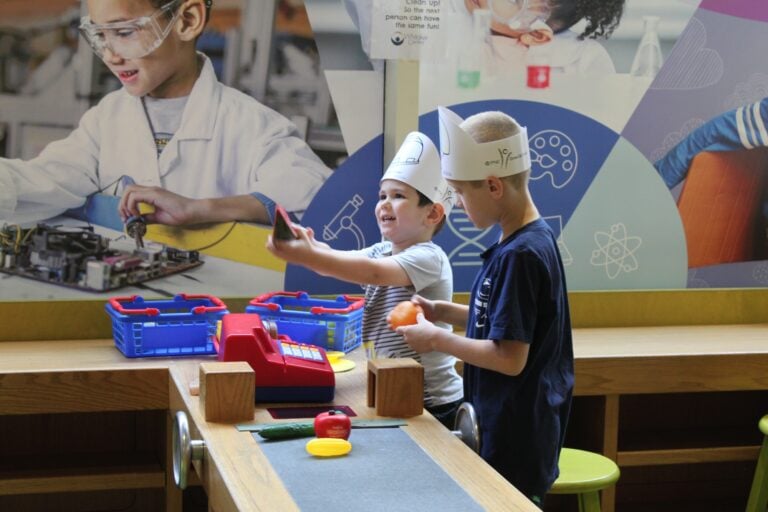 Two Kids in Midtown Market Playing With Fake Food in KidsPlace