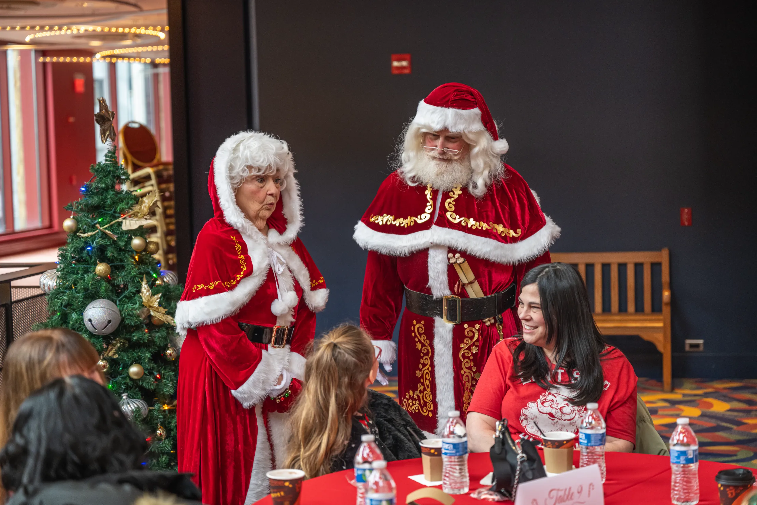 A small child eats breakfast with Santa and Mrs. Claus during Breakfast With Santa at Whitaker Center in 2024.